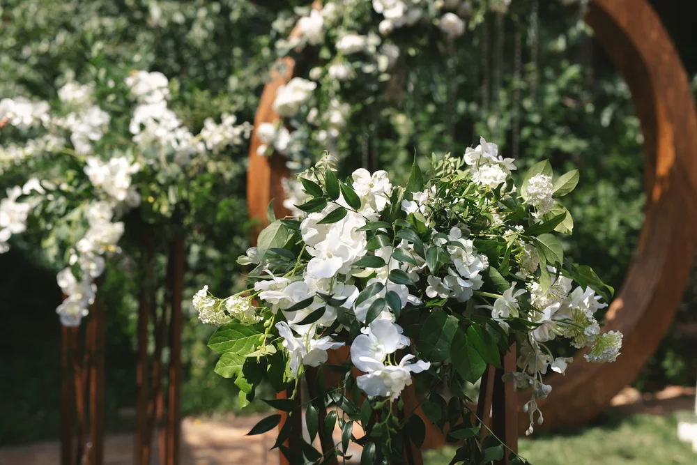 Silk floral arrangements on a wedding arch